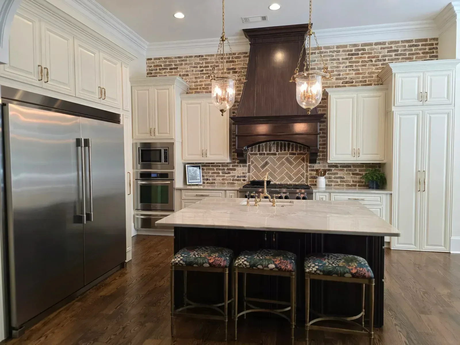 Kitchen with a dark wood island and range hood