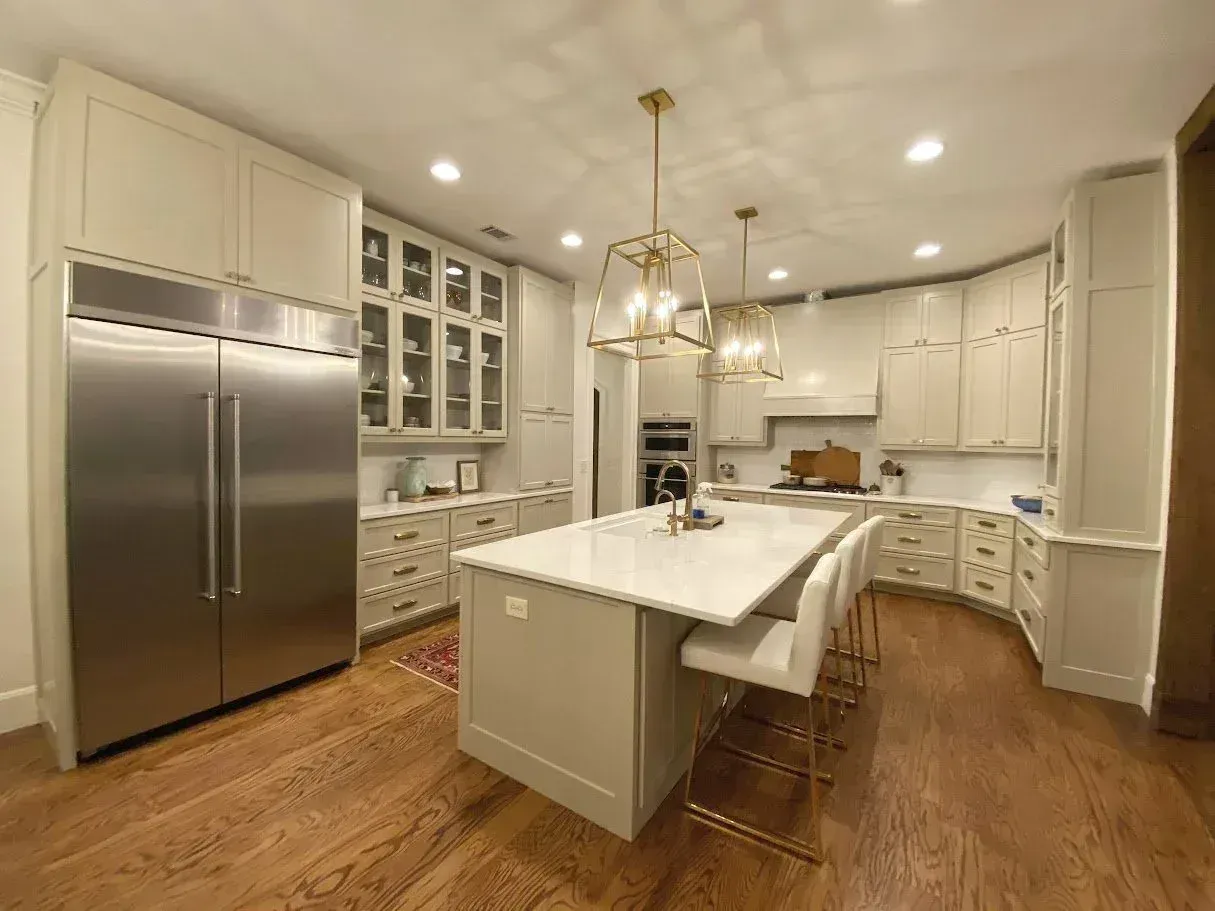 Kitchen with glass-front uppers and a large island