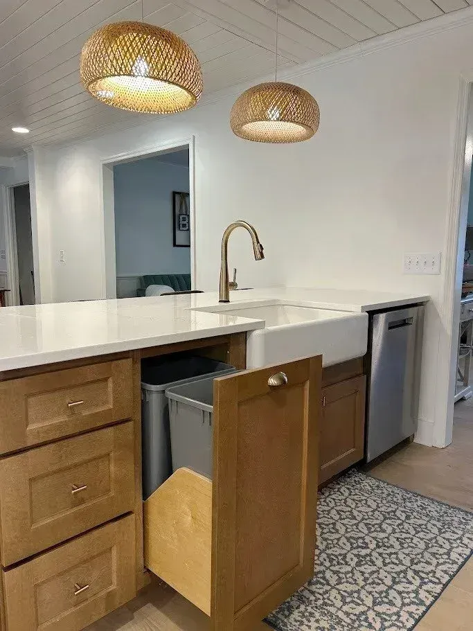 Kitchen island with a trash pullout