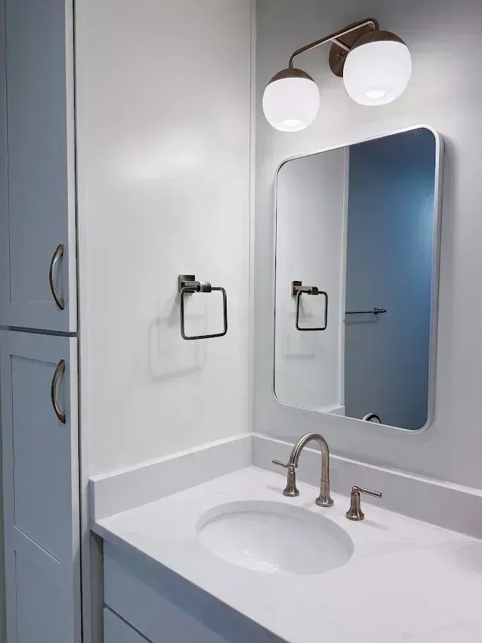 Blue vanity with a round mirror