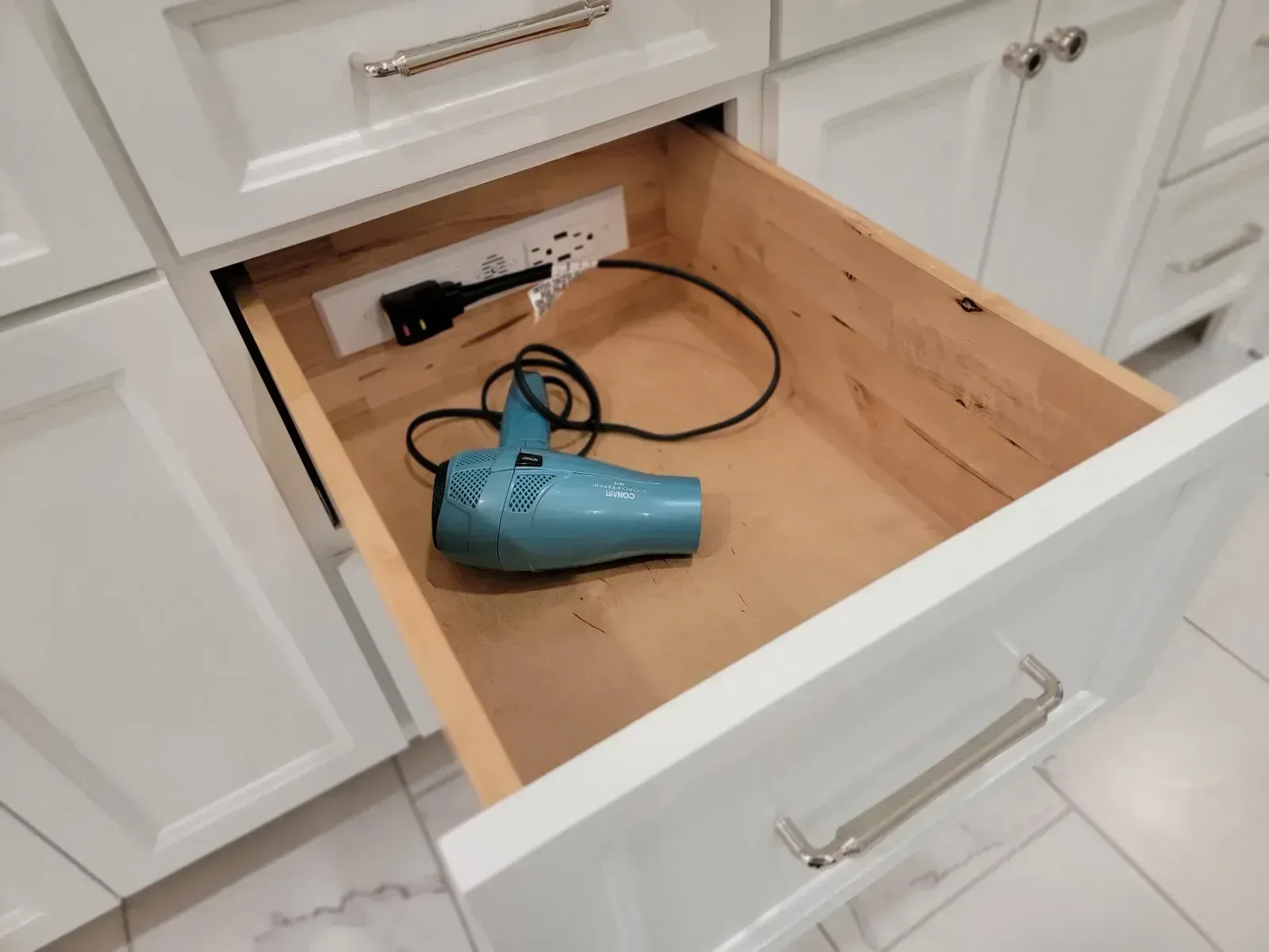 Vanity drawer with a built-in outlet for a hair dryer