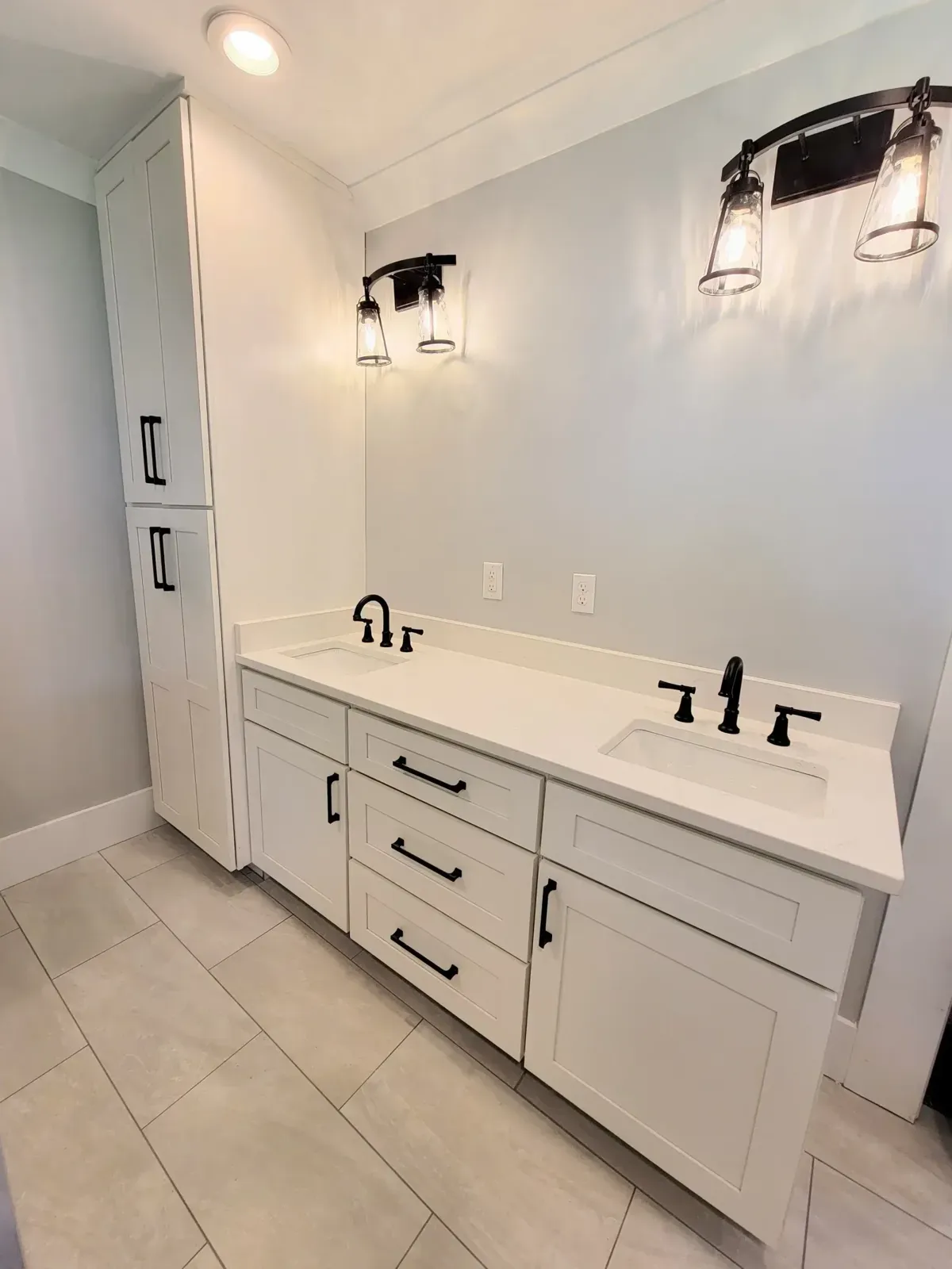 White vanity with black hardware and drawers